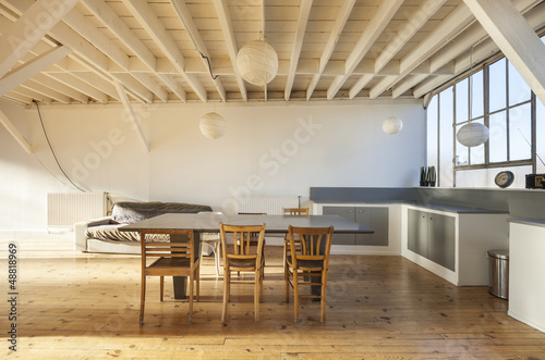 Photo: wide room of loft, beams and wooden floor wide room of loft, beams and wooden floor