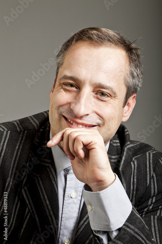 Photo: portrait of adult man isolated on dark background portrait of adult man isolated on dark background