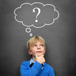 Child at the Blackboard with question Mark