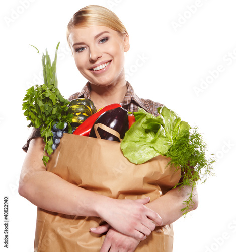 Photo: woman holding a bag full of healthy food. shopping . woman holding a bag full of healthy food. shopping .