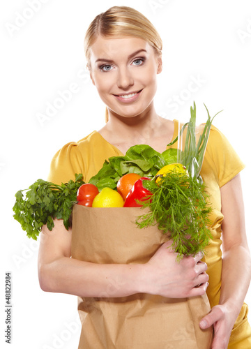 Photo: woman holding a bag full of healthy food. shopping . woman holding a bag full of healthy food. shopping .