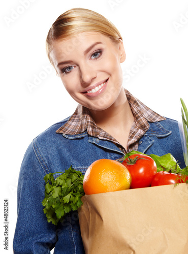 Photo: woman holding a bag full of healthy food. shopping . woman holding a bag full of healthy food. shopping .