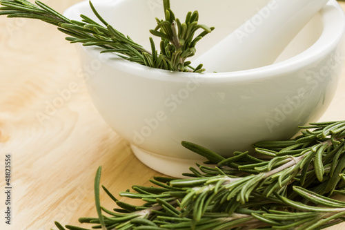 Photo: Ceramic mortar and fresh organic rosemary Ceramic mortar and fresh organic rosemary