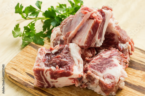 Photo: Fresh raw meat on wooden background Fresh raw meat on wooden background