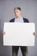 Unhappy man showing white blank panel.
