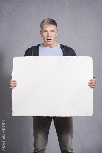 Photo: Disoriented man holding white empty panel. Disoriented man holding white empty panel.