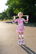 Little girl with rollers outdoors