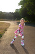 Little girl with rollers outdoors