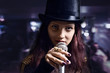 actress with microphone in nightclub