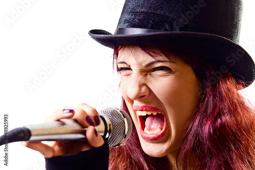 Photo: girl with microphone in black top-hat girl with microphone in black top-hat