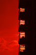 Building silhouette against a burning red sunset