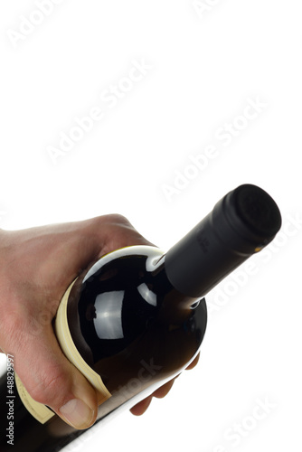 Photo: Hand of a waiter holding a bottle of red wine Hand of a waiter holding a bottle of red wine