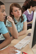 Photo: Students at a computer Students at a computer