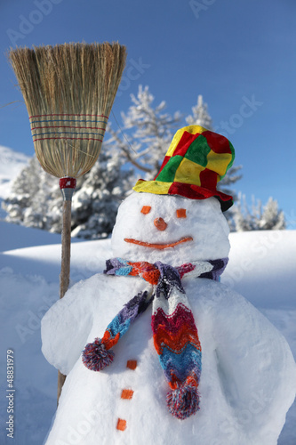 Photo: Funny snowman holding broom stick Funny snowman holding broom stick