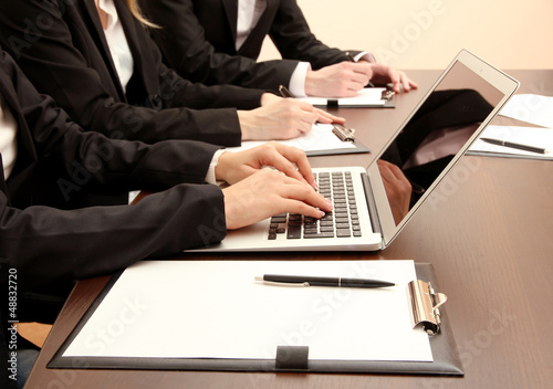 Photo: Close up of business people hands during teamwork Close up of business people hands during teamwork