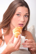 young woman having her breakfast in bed
