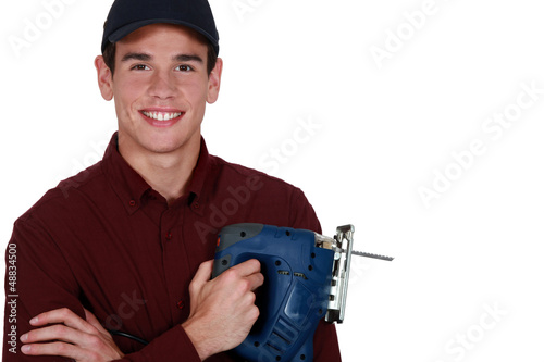 Photo: Young man holding a jigsaw Young man holding a jigsaw