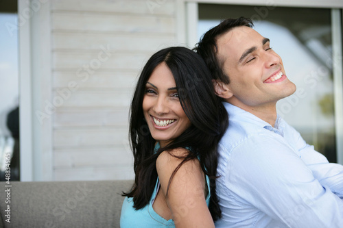 Photo: happy couple back to back happy couple back to back