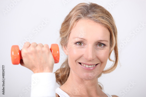 Photo: portrait of a woman with dumbbell portrait of a woman with dumbbell