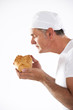 Baker smelling bread loaf