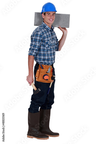 Photo: young mason carrying a stone block young mason carrying a stone block