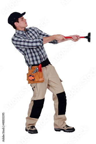 Photo: Handyman pulling a plunger Handyman pulling a plunger