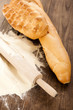 Still life of bread and rolling pin with flour