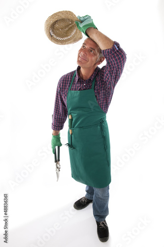 Photo: Gardener holding gardening tool Gardener holding gardening tool