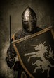 Medieval knight with sword and shield against stone wall