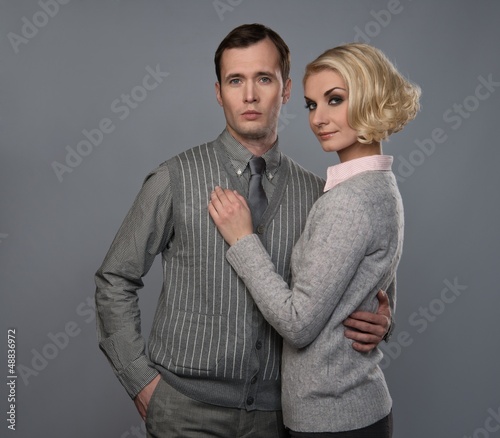 Photo: Elegant couple isolated on grey background Elegant couple isolated on grey background