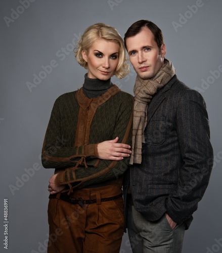 Photo: Elegant couple isolated on grey background Elegant couple isolated on grey background