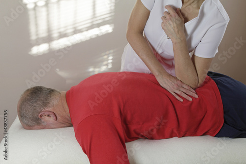 Photo: Applying pressure with elbow into lower back Applying pressure with elbow into lower back