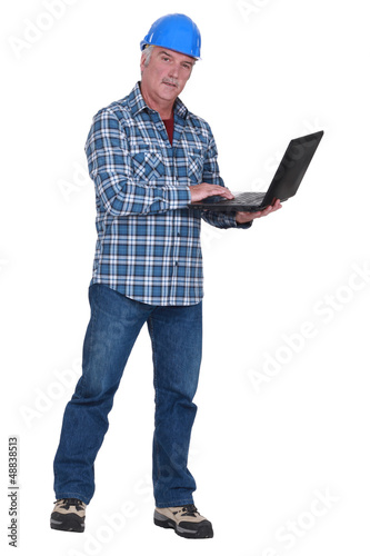 Photo: Experienced tradesman embracing technology Experienced tradesman embracing technology