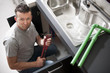 Plumber working on kitchen sink