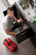 Plumber working on kitchen sink