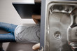 Plumber working on kitchen sink