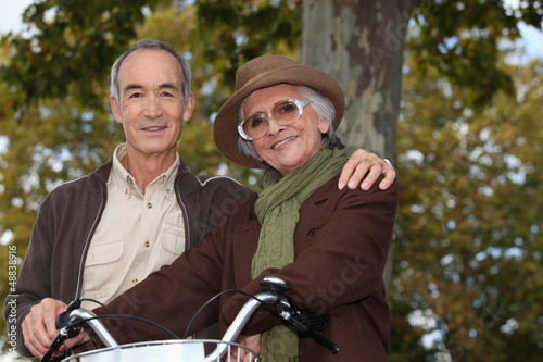 Photo: Elderly couple on a bike ride in the forest Elderly couple on a bike ride in the forest