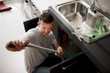 Plumber working on kitchen sink