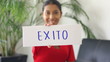 Young woman holding a success sign