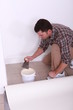 Man sticking carpet