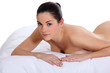 Portrait of a nude woman lying on a mattress