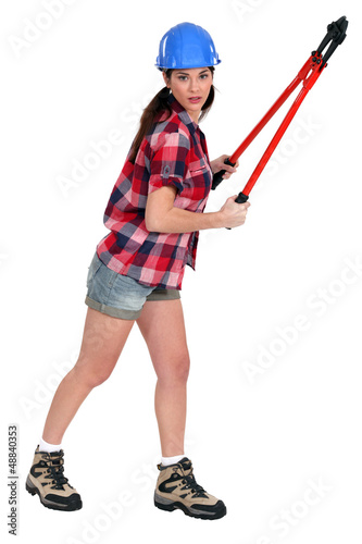 Photo: woman wearing shorts holding bolt-cutters woman wearing shorts holding bolt-cutters