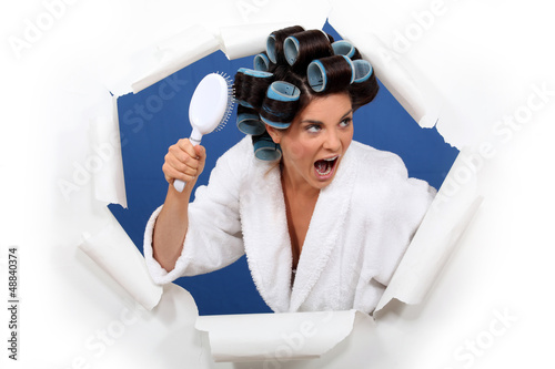 Photo: Angry woman with hair rollers and brush Angry woman with hair rollers and brush