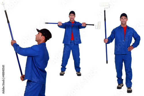 Photo: Multiple shot of decorator using long roller Multiple shot of decorator using long roller