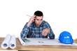 architect in office having a headache