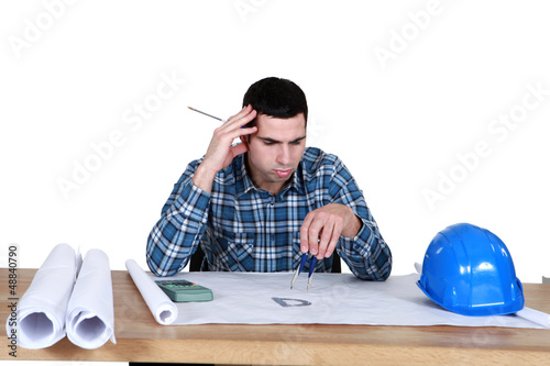 Photo: architect in office having a headache architect in office having a headache