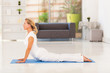 elegant mature lady doing yoga at home