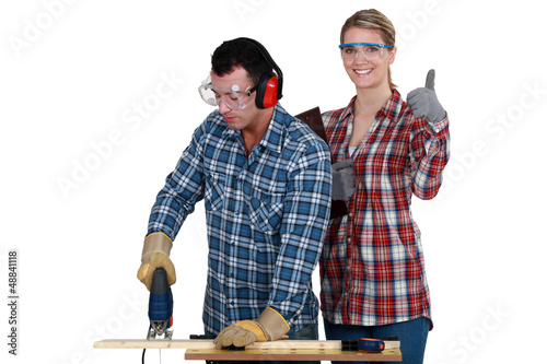 Photo: Woman inspecting carpenter Woman inspecting carpenter