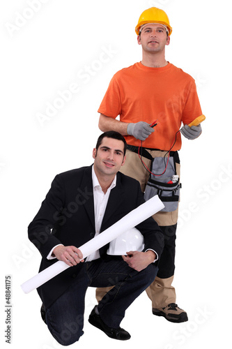 Photo: Architect kneeling by electrician Architect kneeling by electrician
