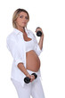Pregnant woman using handweights
